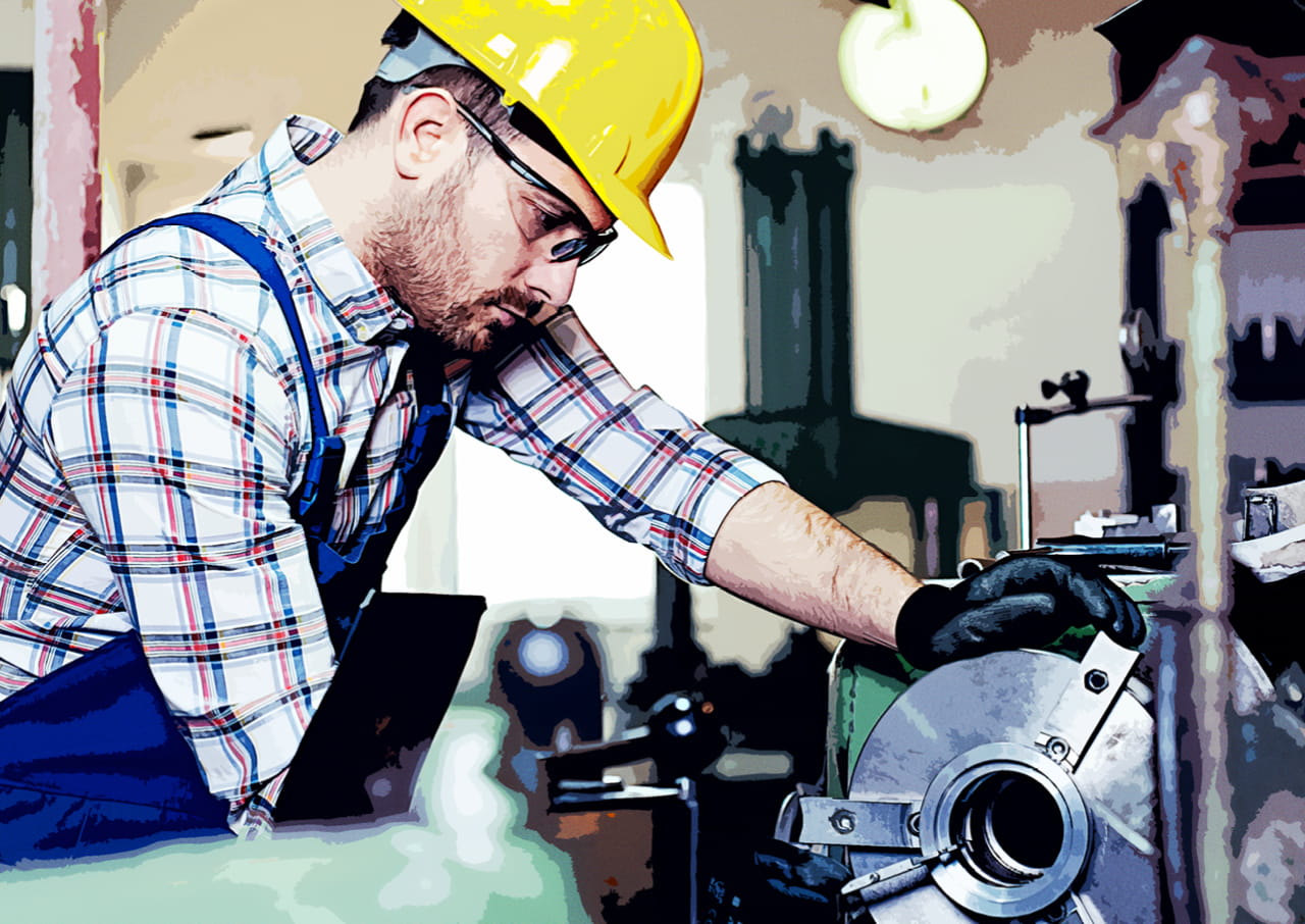 A person wearing a hard hat operating machinery.