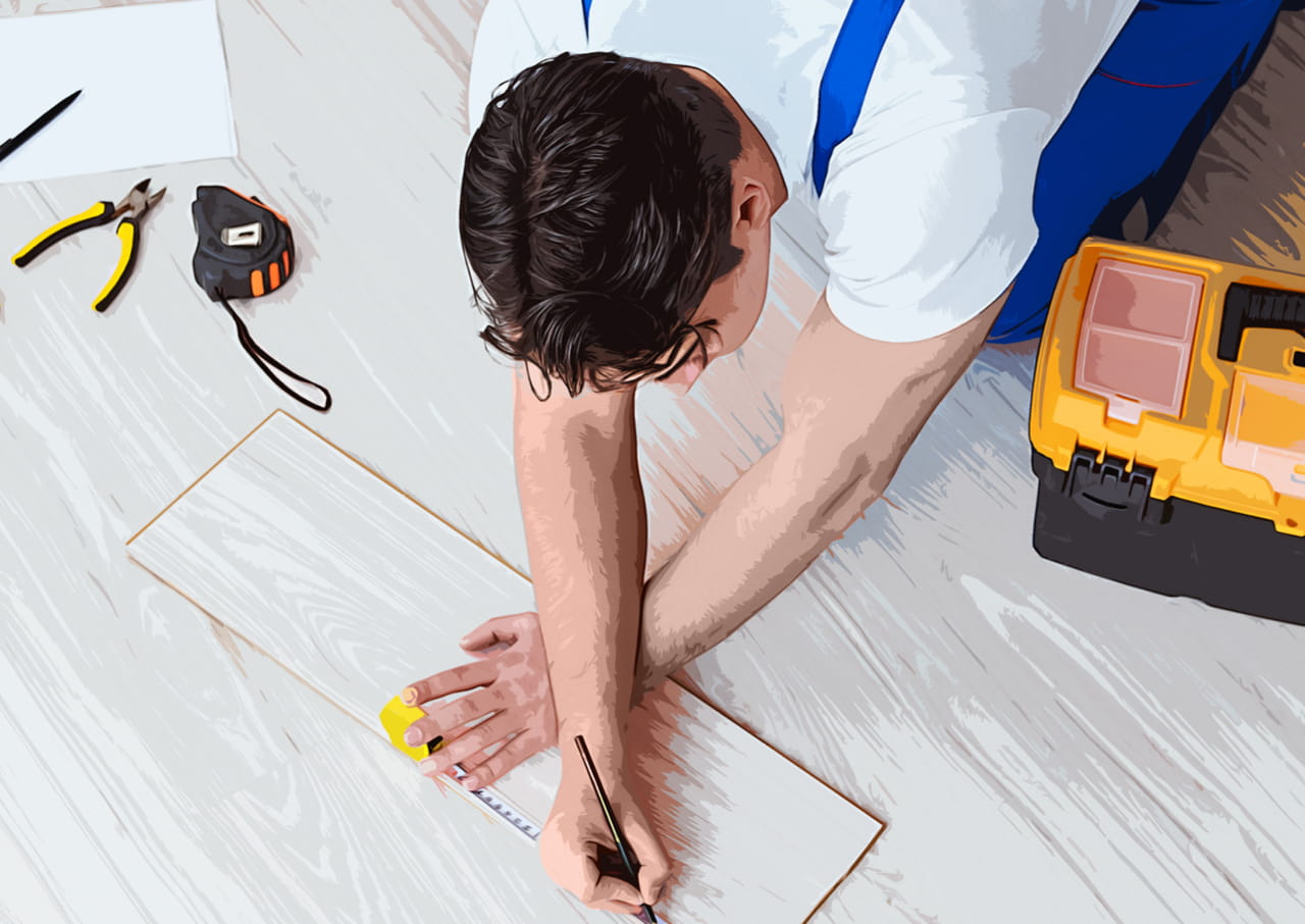 A contractor laying wooden flooring.